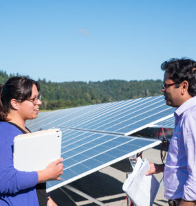 Two students in conversation at the foot of the array.