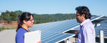 Two students in conversation at the foot of the array.
