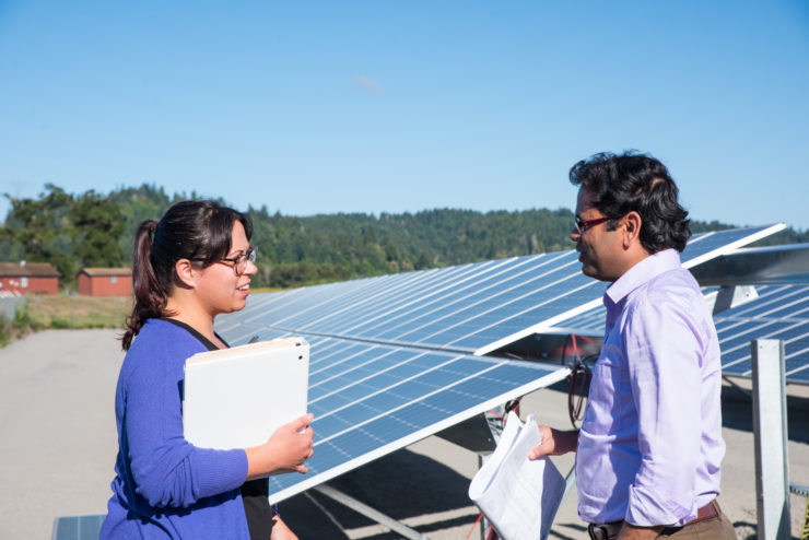 Two students in conversation at the foot of the array.