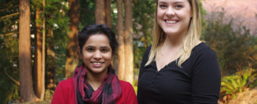 Two fellows stand outside the West Wing.