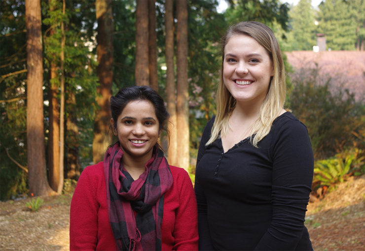 Two fellows stand outside the West Wing.