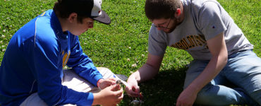 A student and counselor construct a simple solar circuit