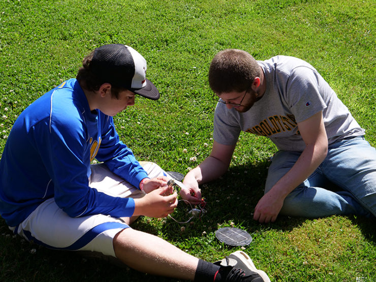 A student and counselor construct a simple solar circuit