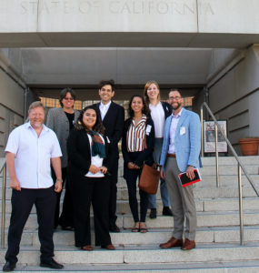 Researchers and Commissioner Douglas stand together on steps