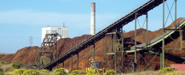 View of biomass pile and smokestack