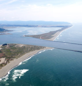 Aerial image of south Humboldt Bay and its jetties, extending into the Pacific