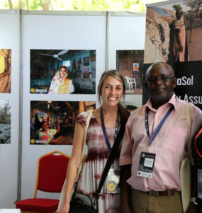 3 people stand together in a booth with VeraSol posters behind them