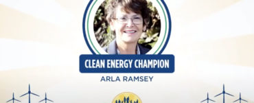 A smiling woman with the caption "Clean Energy Champion: Arla Ramsey" beneath her photo.