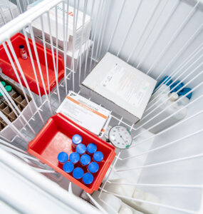Vials inside a top-loading vaccine refrigerator