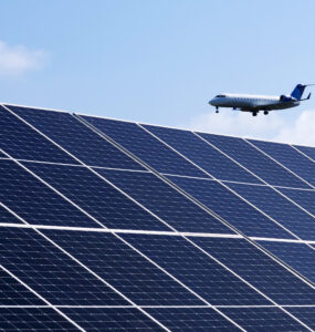 An airplane flies above the microgrid's solar array