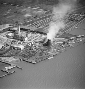 Black and white aerial photo of a power plant and lumber mill on Humboldt Bay